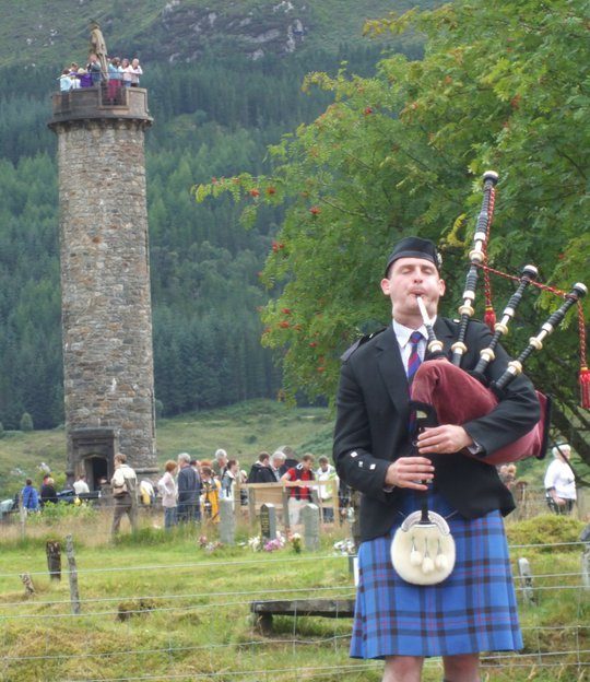 A piper at Glenfinnan Games beneath the Jacobite Monument