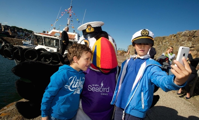 Selfie Time at the Forth Ferry. Laird and Radleigh snap a pic with the Scottish Seabird Centre’s Tammie the Puffin. Photo by Rob MacDougall