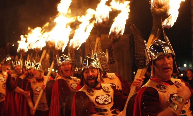 Blazing torches are carried to the top of Calton Hill in the Torchlight Procession. Photo by Lloyd Smith