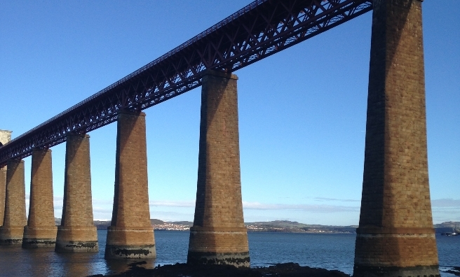 Early morning sunshine hits the Forth Rail Bridge at the start of our hike