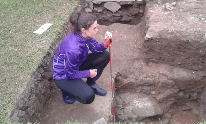 One of the Trailblazer volunteers records the medieval walls uncovered during the excavation.