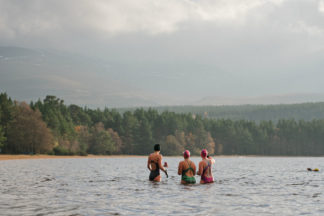 Group of three female wild swimmers in Loch Insh