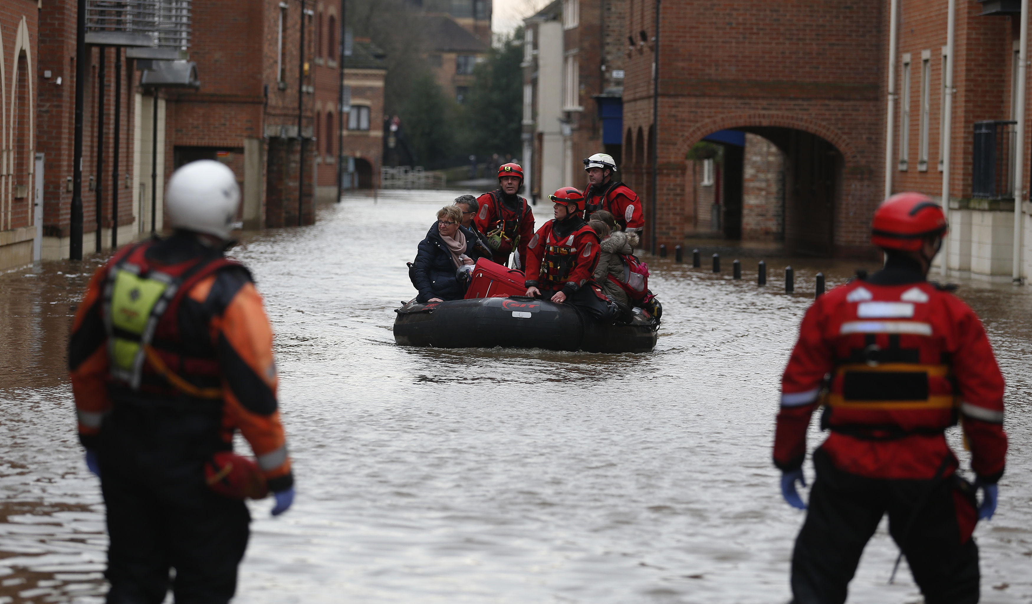 A family is rescued from the centre of York by boat (Owen Humphreys / PA Wire)