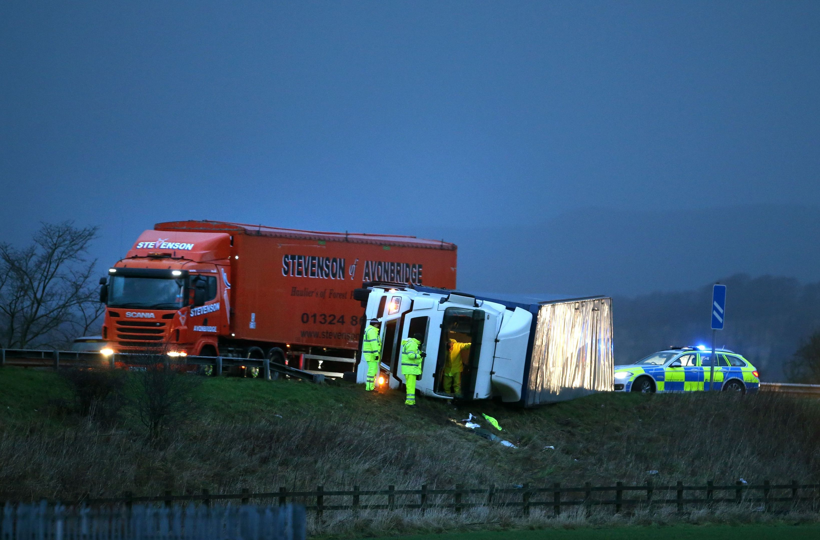 Police at the scene of an overturned lorry on the M9 near Falkirk (Andrew Milligan/PA Wire)