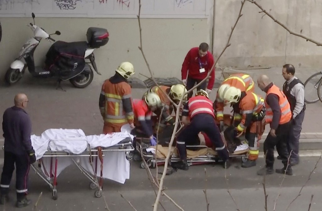 Emergency rescue workers stretcher an unidentified person at the site of an explosion at a metro station in Brussels (APTN via AP)