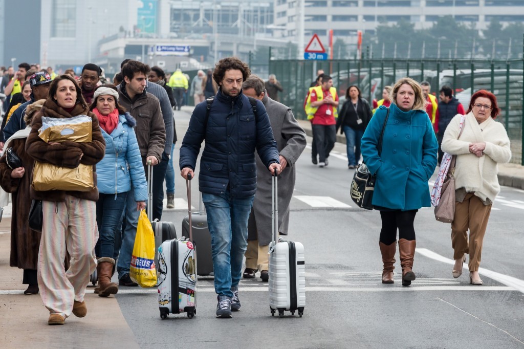 Travellers leave the airport (AP Photo/Geert Vanden Wijngaert)