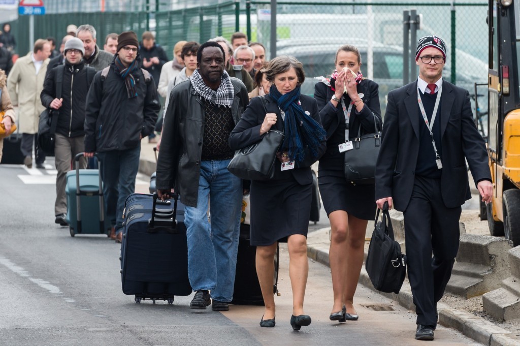 Travellers leave the airport (AP Photo/Geert Vanden Wijngaert)