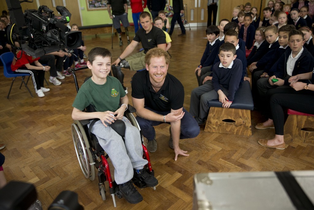 Prince Harry watches a monitor alongside Craig, aged 10 (Matt Dunham - WPA Pool/Getty Images)