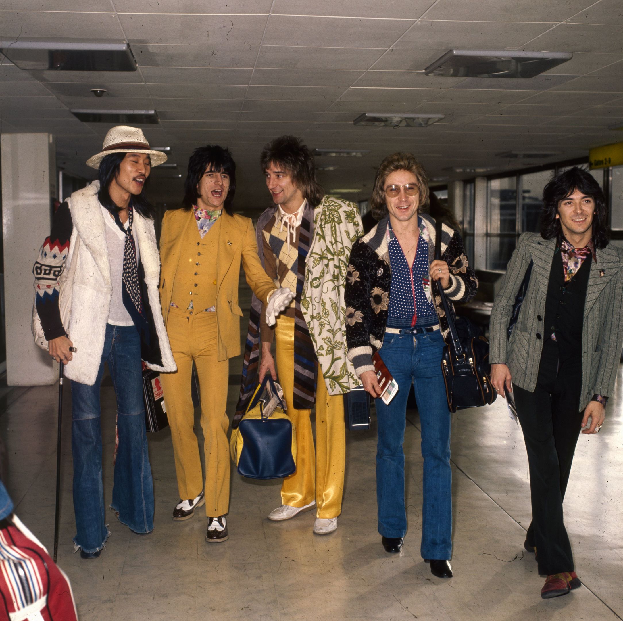 Rod Stewart with the Faces at London Airport. From left to right are: Tetsu Yamauchi, Ron Wood, Rod Stewart, Kenny Jones, and Ian McLagan. (Dennis Stone/Express/Getty Images)