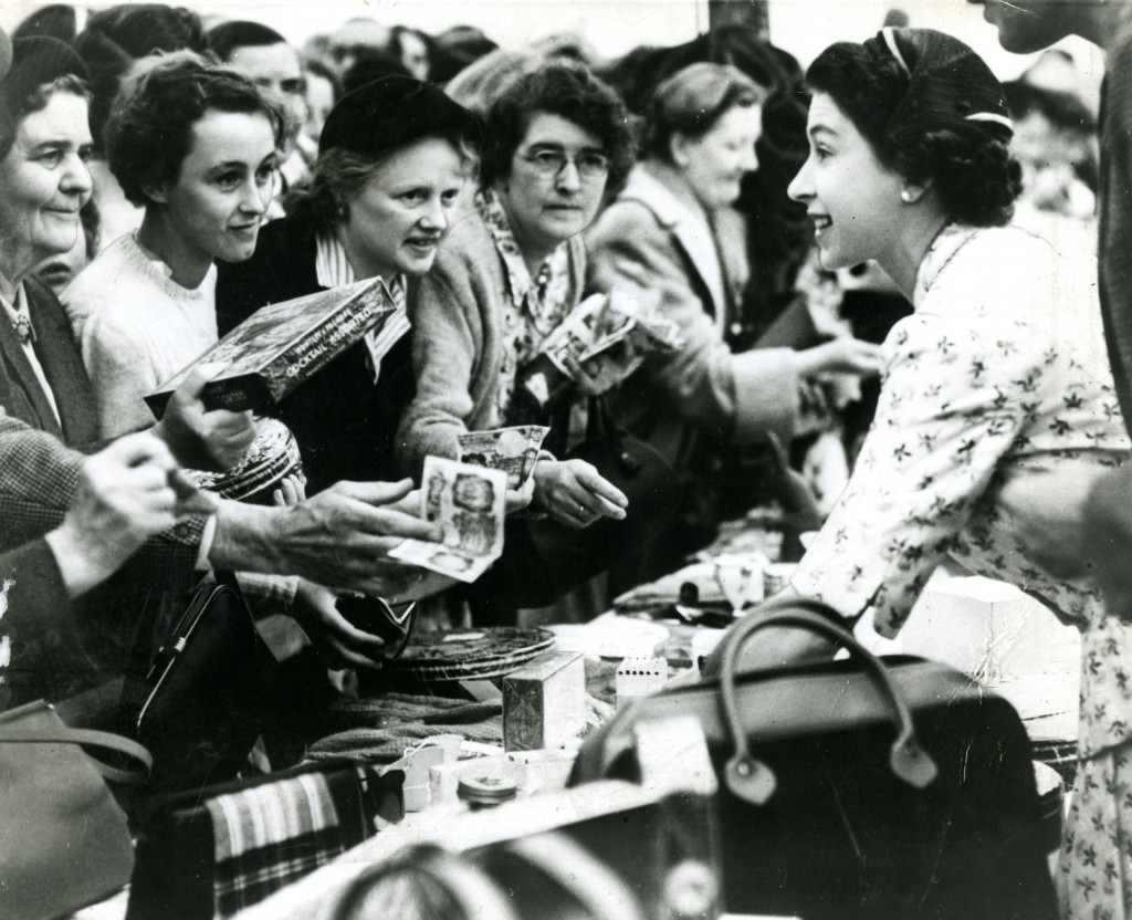 The new Queen meets some Scottish ladies at Abergeldie in Aberdeenshire. Manning a stall at a fete, she seems in her element chatting to ordinary folk (DC Thomson)