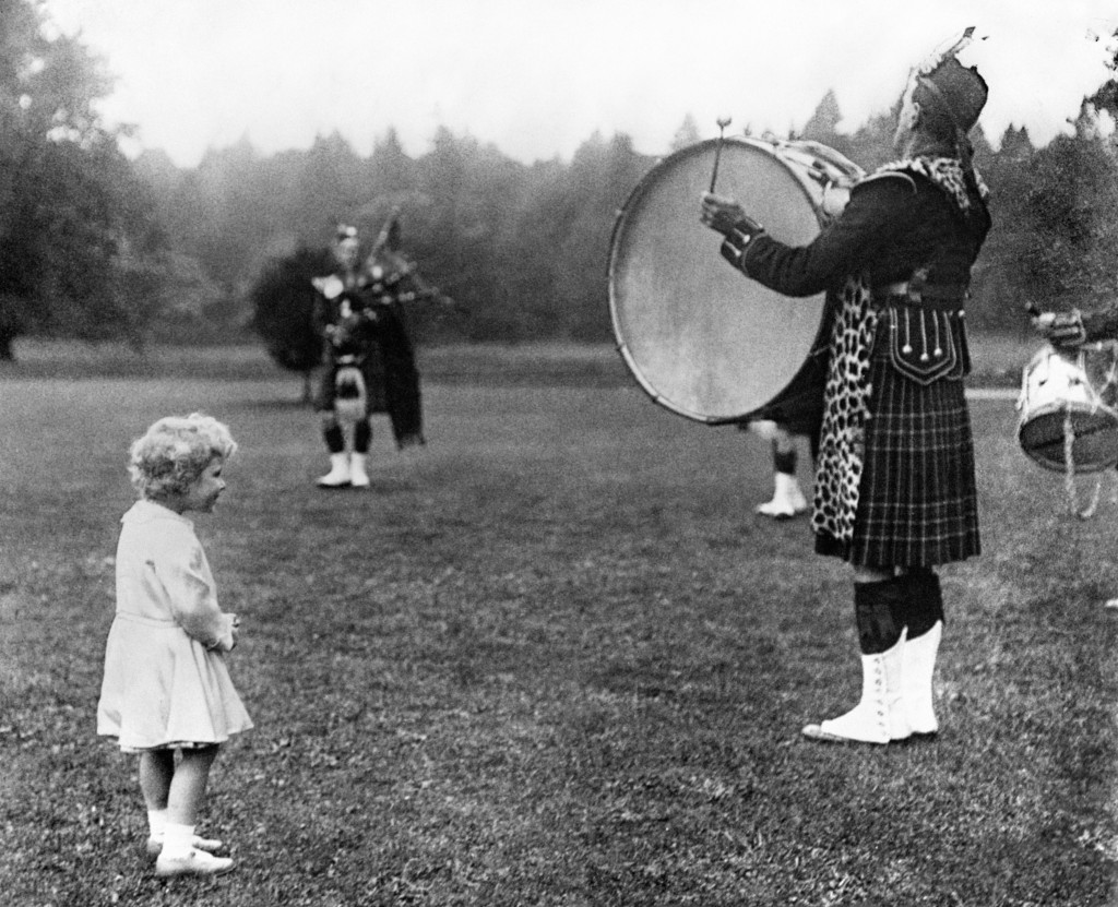 Princess Elizabeth is clearly enjoying the sound of the big bass drum during a visit to Scotland in 1929 (DC Thomson)