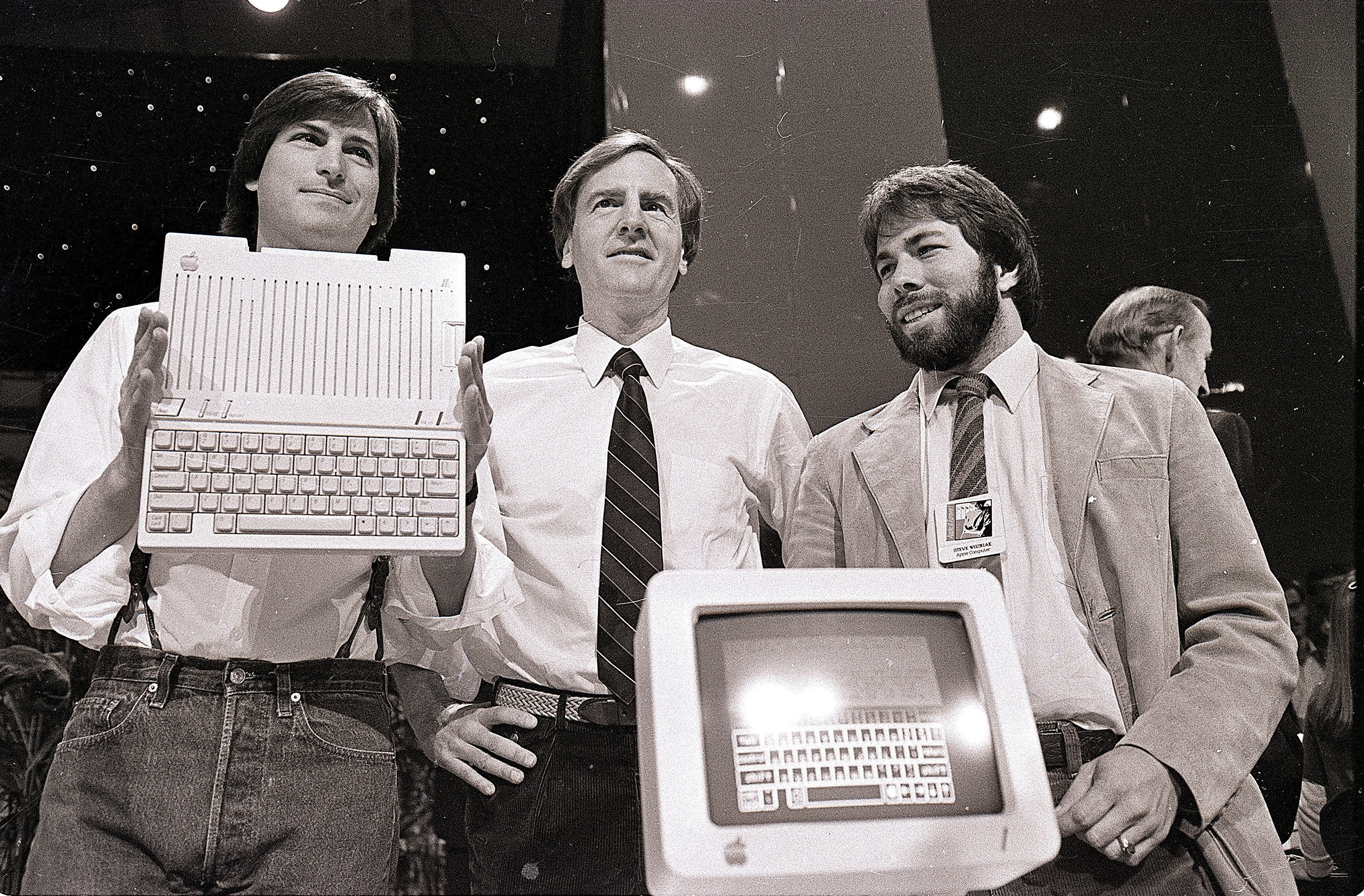 Steve Jobs, left, chairman of Apple Computers, John Sculley, centre, president and CEO, and Steve Wozniak, co-founder of Apple, unveil the new Apple IIc computer in San Francisco. (AP Photo/Sal Veder, File)