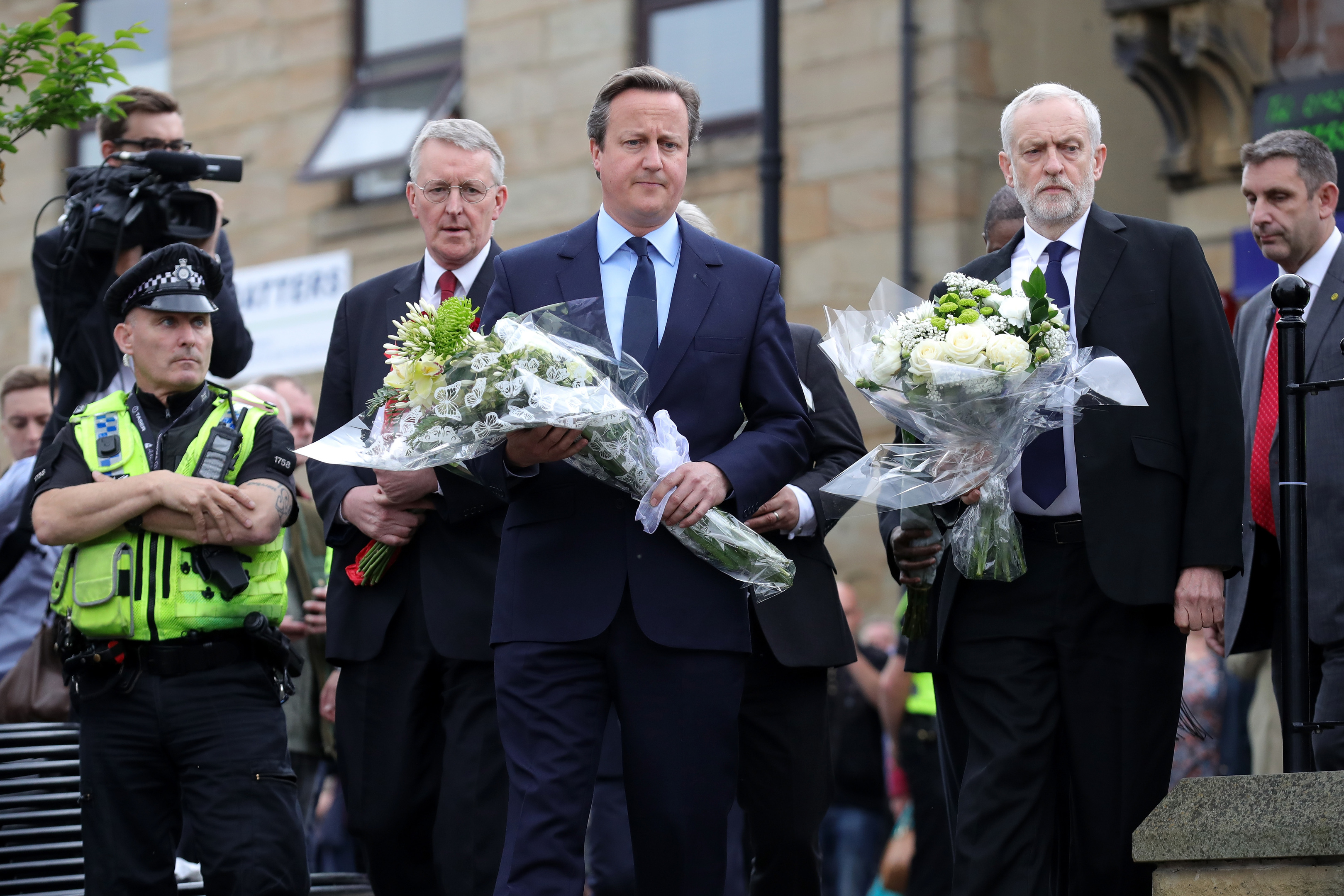 Prime Minister David Cameron and Labour Leader Jeremy Corbyn arrive to pay their respects at the scene of the murder of Jo Cox, 41, Labour MP for Batley and Spen, who was shot and stabbed yesterday at her constituency surgery (Christopher Furlong/Getty Images)