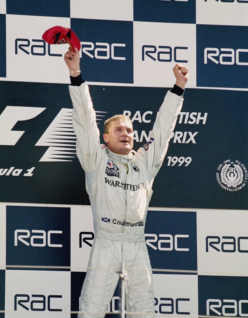 David celebrates on the podium after winning the British Grand Prix in 1999 (Michael Cooper/Getty Images)