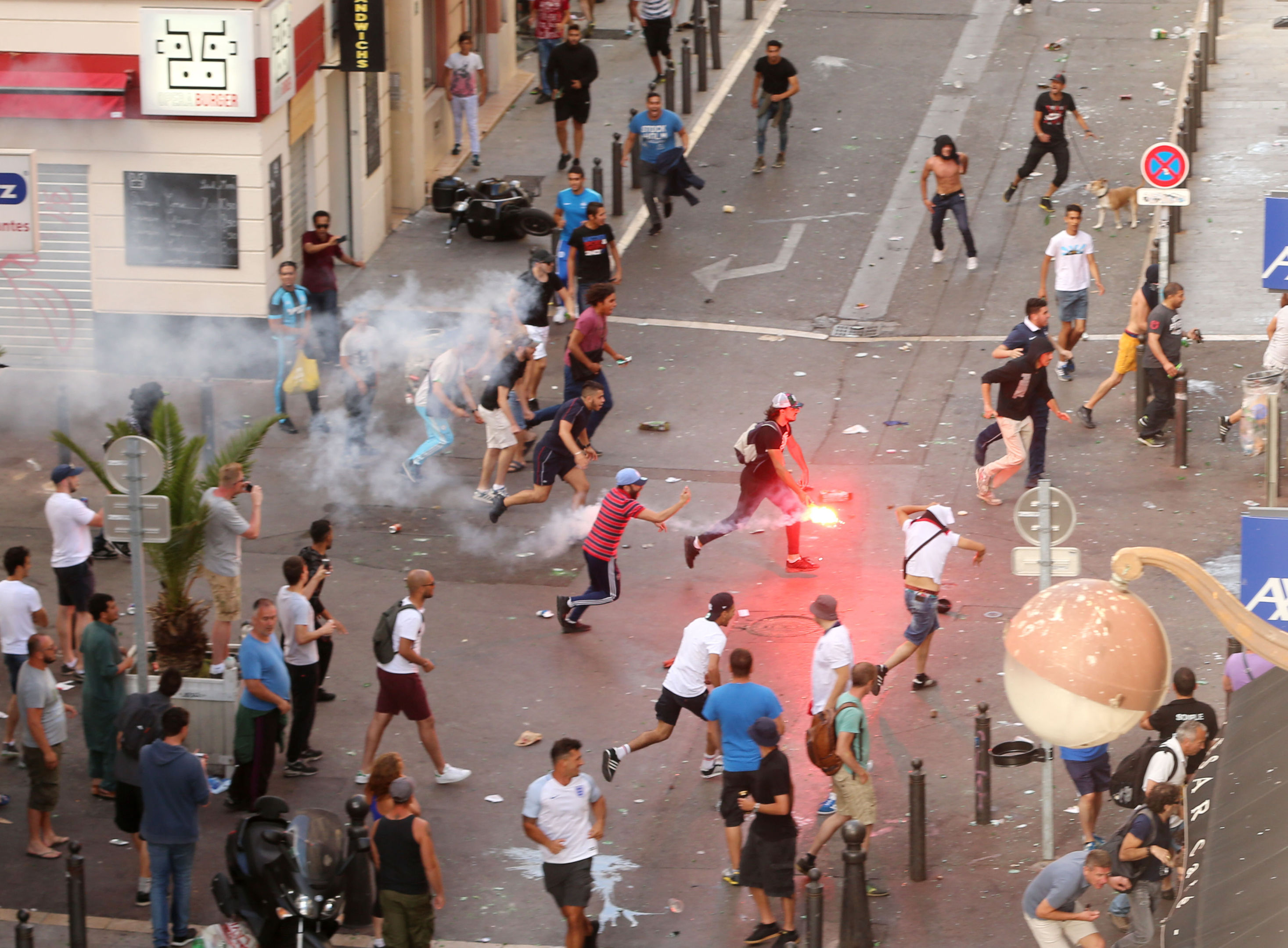 A fan runs with a flare ahead of the England vs Russia France Euro 2016 match, in Marseille, France (Niall Carson/PA)