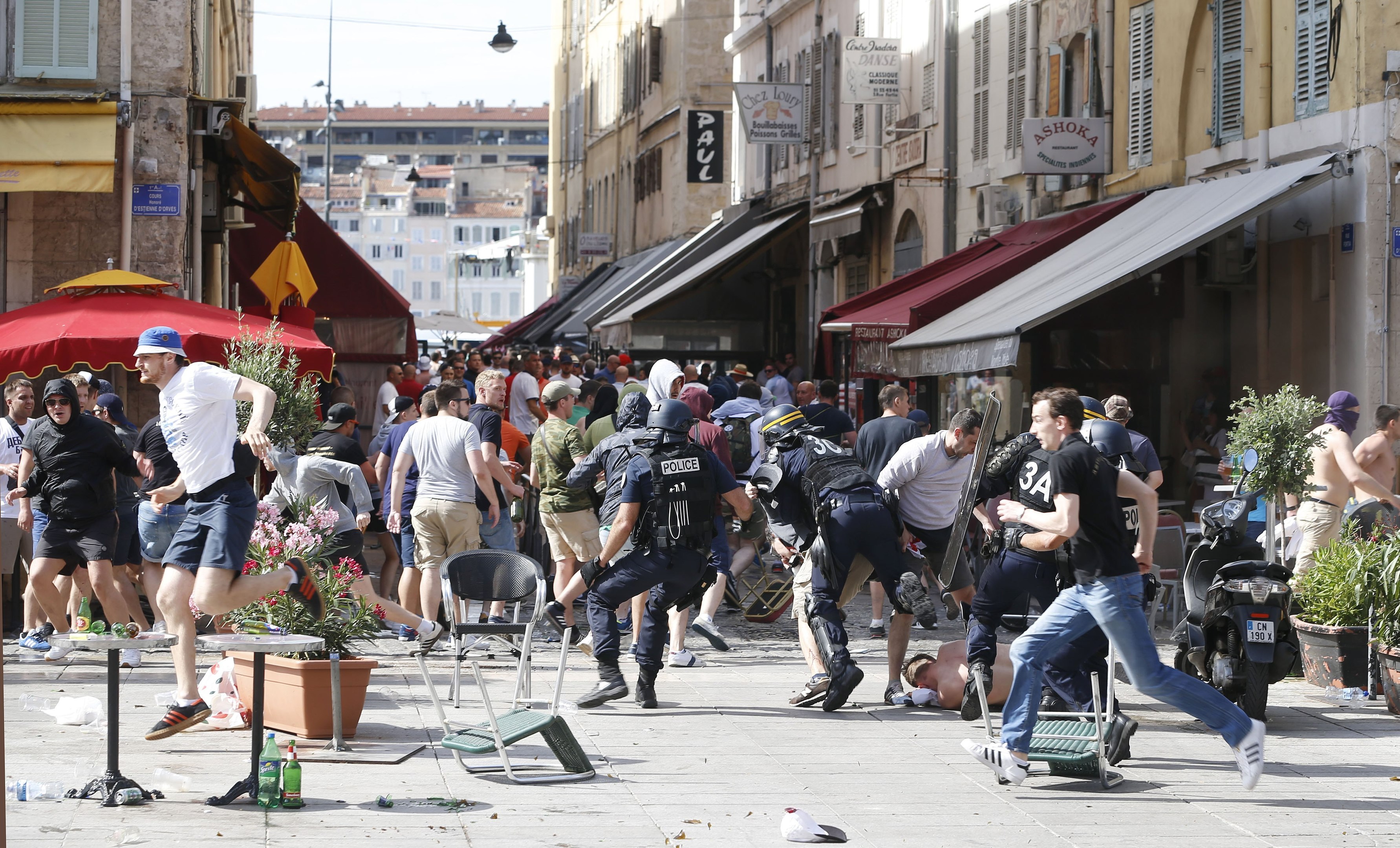 French police officers charge supporters during clashes in downtown Marseille, France (AP Photo/Darko Bandic)