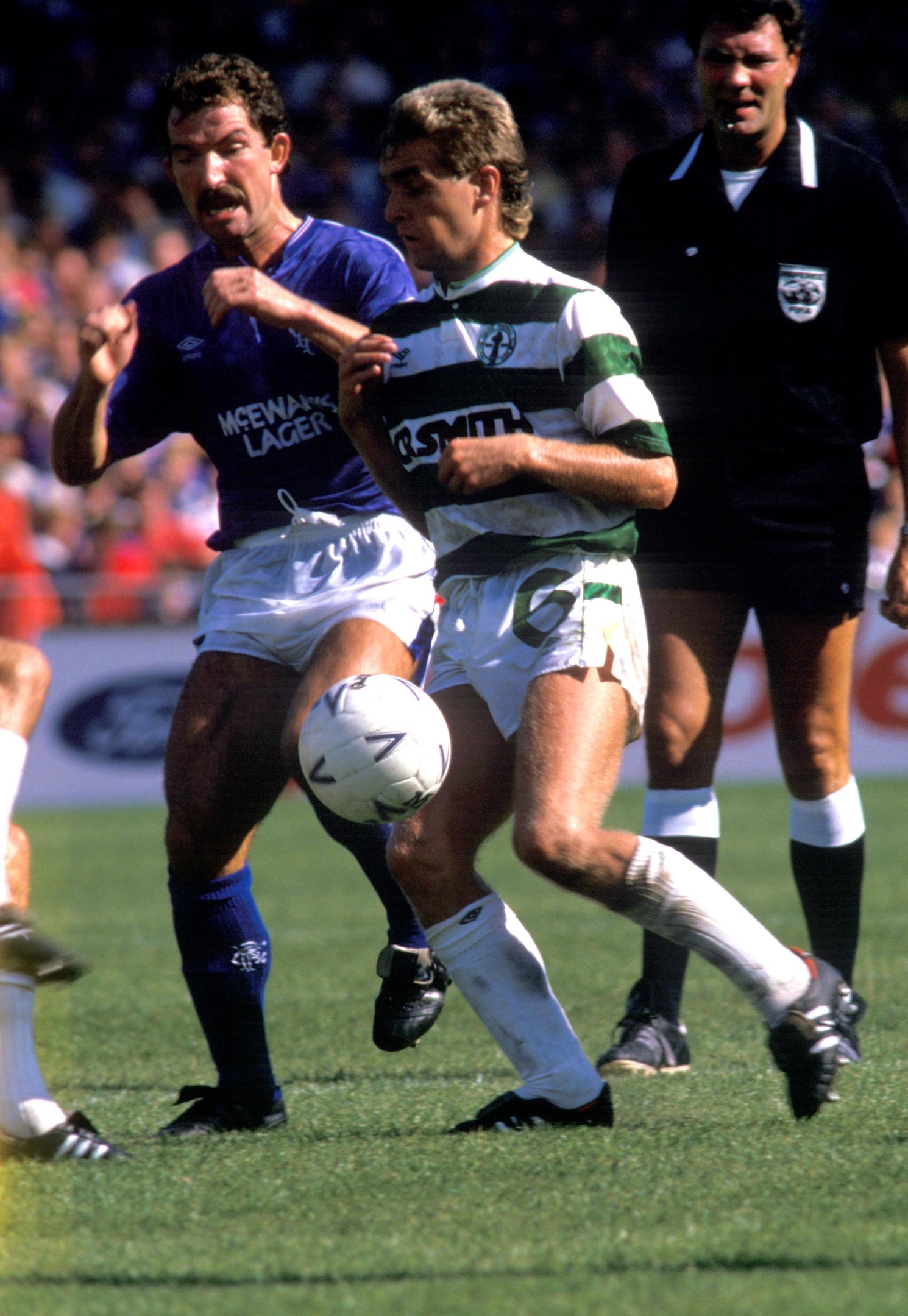 Graeme Souness (left) clashes with Peter Grant closely watched by referee David Syme
