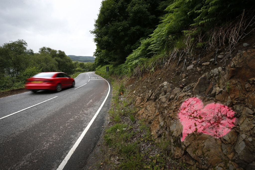 A heart is painted on rocks at the side of the A816 near to where a car crashed (Jane Barlow/PA Wire)