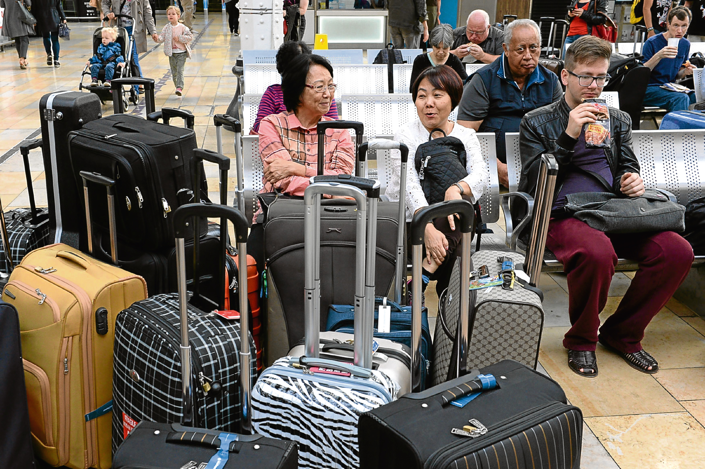 Passengers wait at Paddington Station in west London as members of the Rail, Maritime and Transport union at First Great Western (FGW) are walk out for three days in a row over new trains.