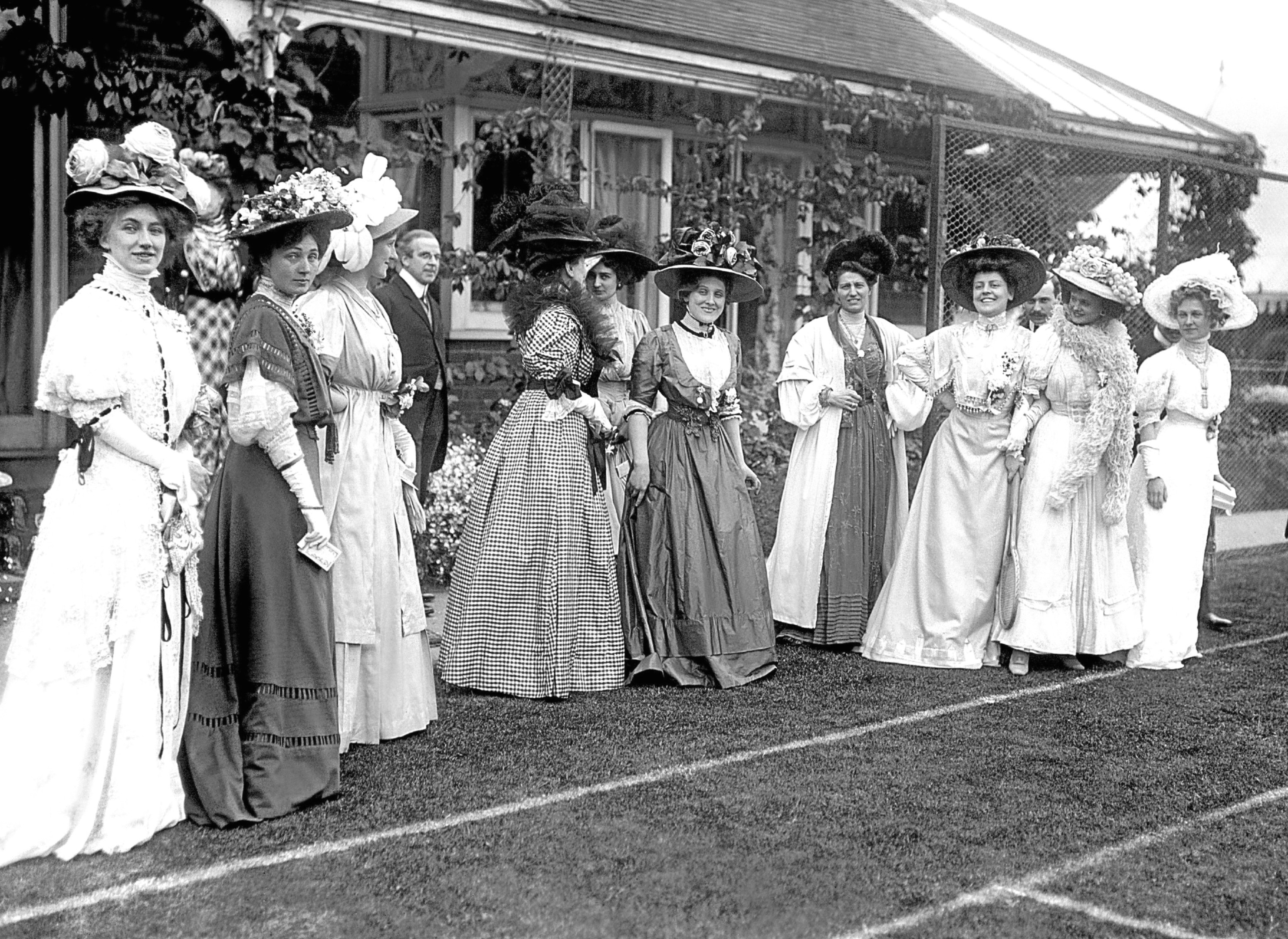 Edwardian fashion being displayed by elegantly dressed ladies during a tennis party at stage celebrity Edna May's wedding.