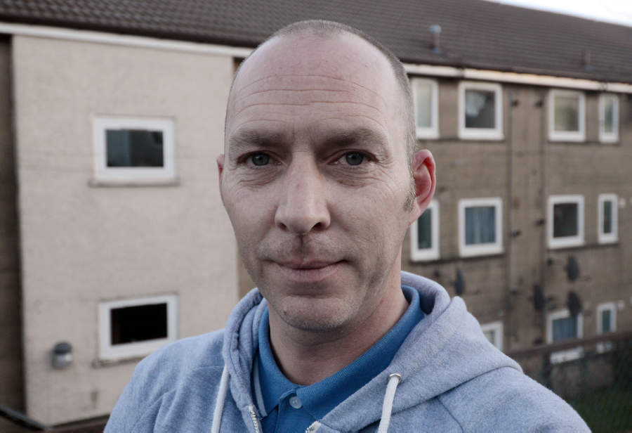 John Davis, aged 40, outside his home on Maple Road in Greenock, Inverclyde, who has been cleared of racially abusing his neighbour (Hemedia)