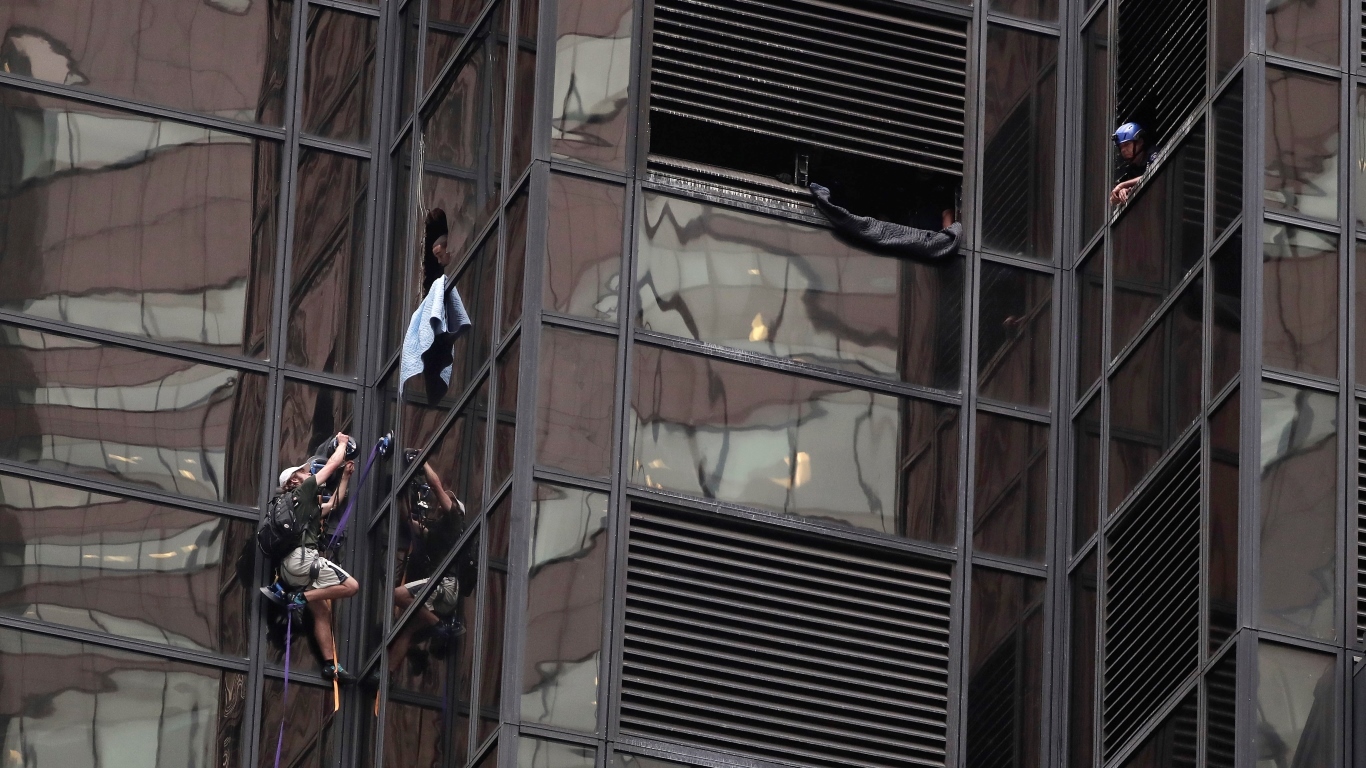 A man scales the east side of Trump Tower using suction cups (AP Photo/Julie Jacobson)