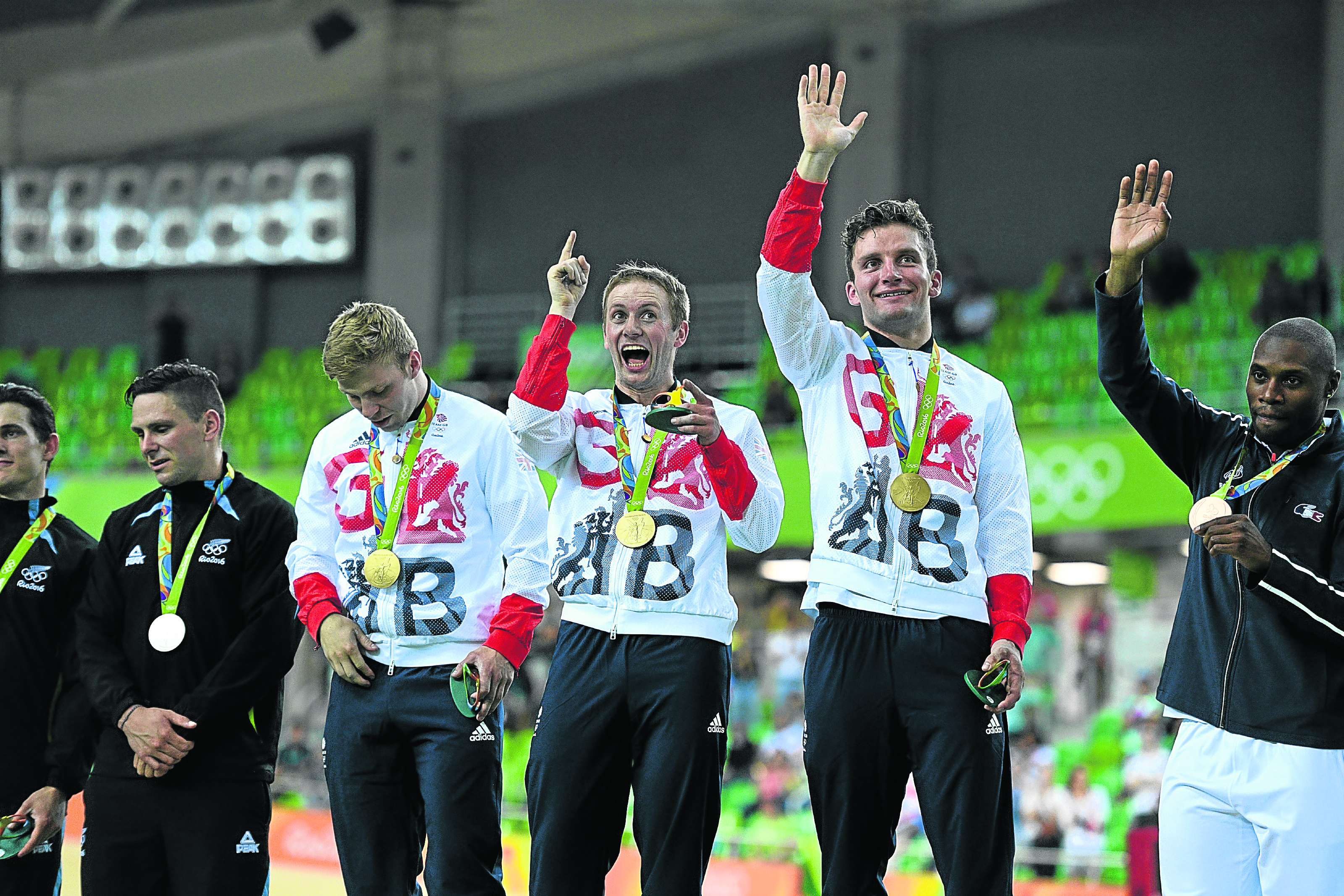 Gold medallists Philip Hindes, Jason Kenny and Callum Skinner of Great Britain celebrate after the Men's Team Sprint Track Cycling Finals (Photo by David Ramos/Getty Images)