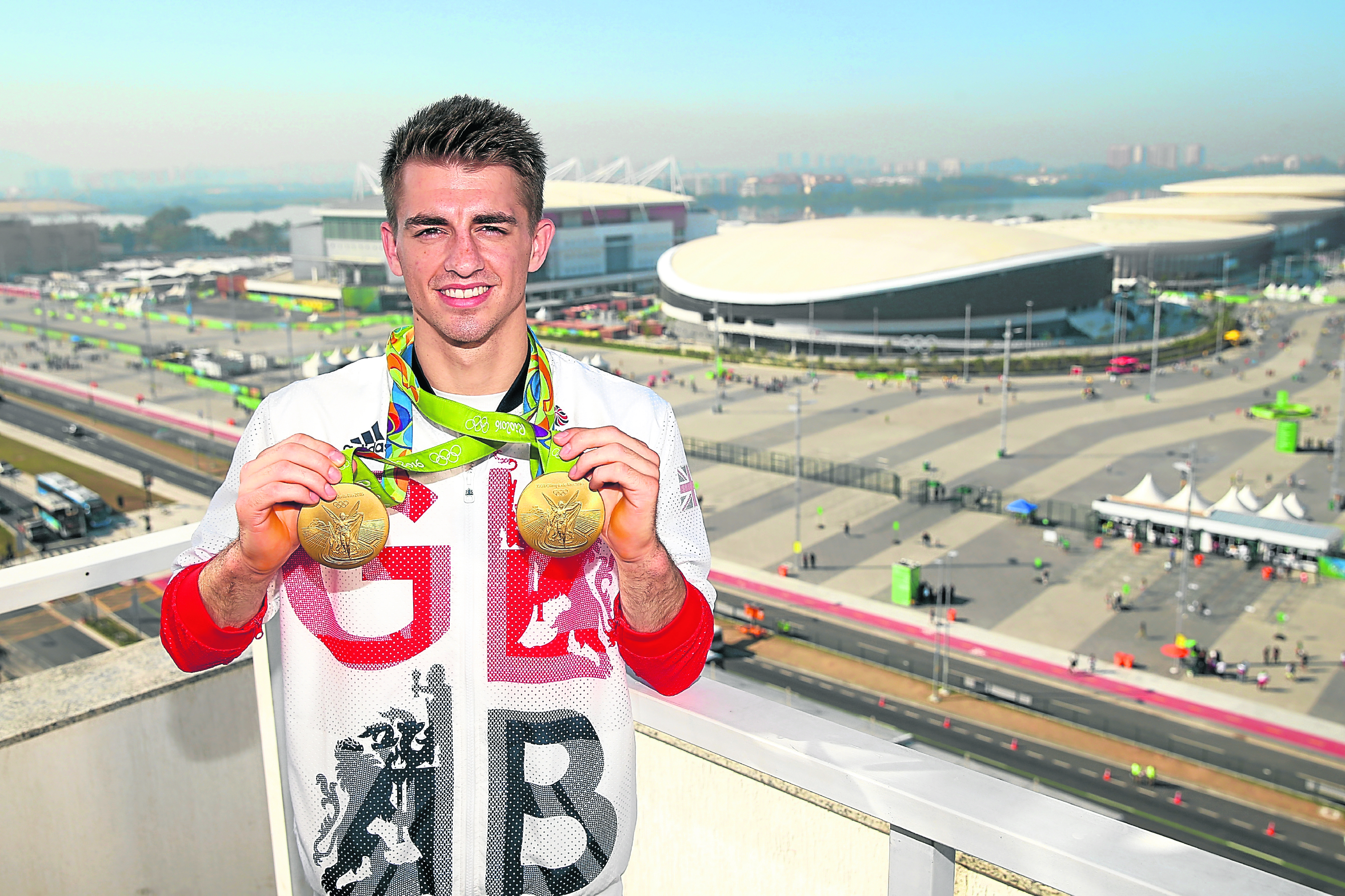 Max Whitlock of Great Britain poses for photographs with his two gold medals in front of the Olympic Park (Photo by Alex Livesey/Getty Images)