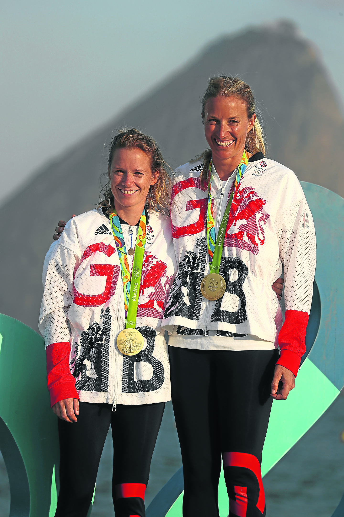 Hannah Mills of Great Britain (left) and Saskia Clark of Great Britain pose with their gold medals after winning the womens 470 class medal race at the Marina da Gloria (Photo by Clive Mason/Getty Images)