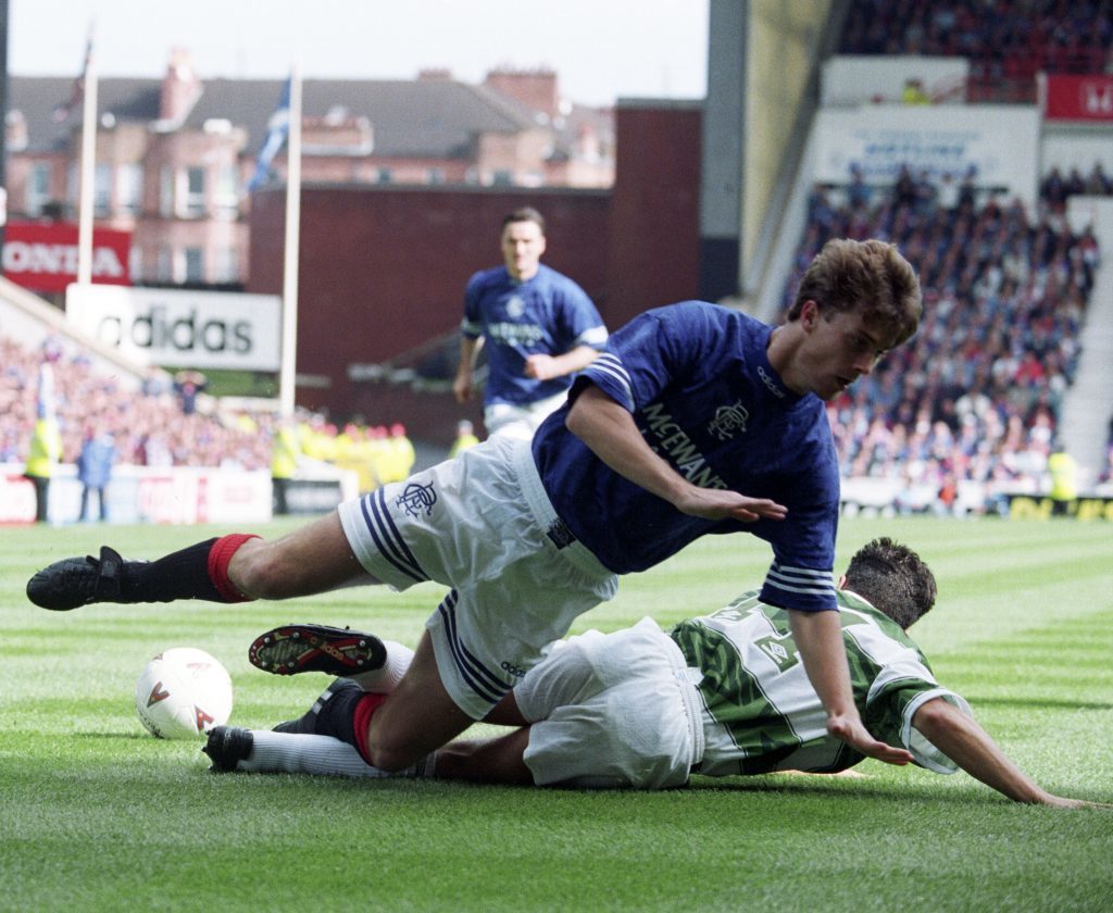 Brian Laudrup loses his footing in a challenge with Celtic's John Collins (SNS Group)