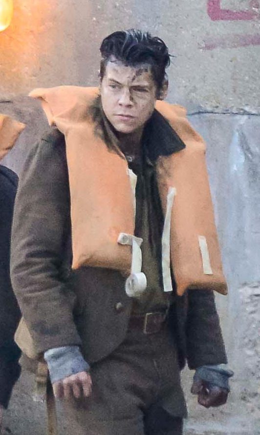 Harry Styles on a pontoon with extras dressed as soldiers during the filming of Dunkirk at Weymouth Harbour in Dorset (Graham Hunt/Alamy Live News)