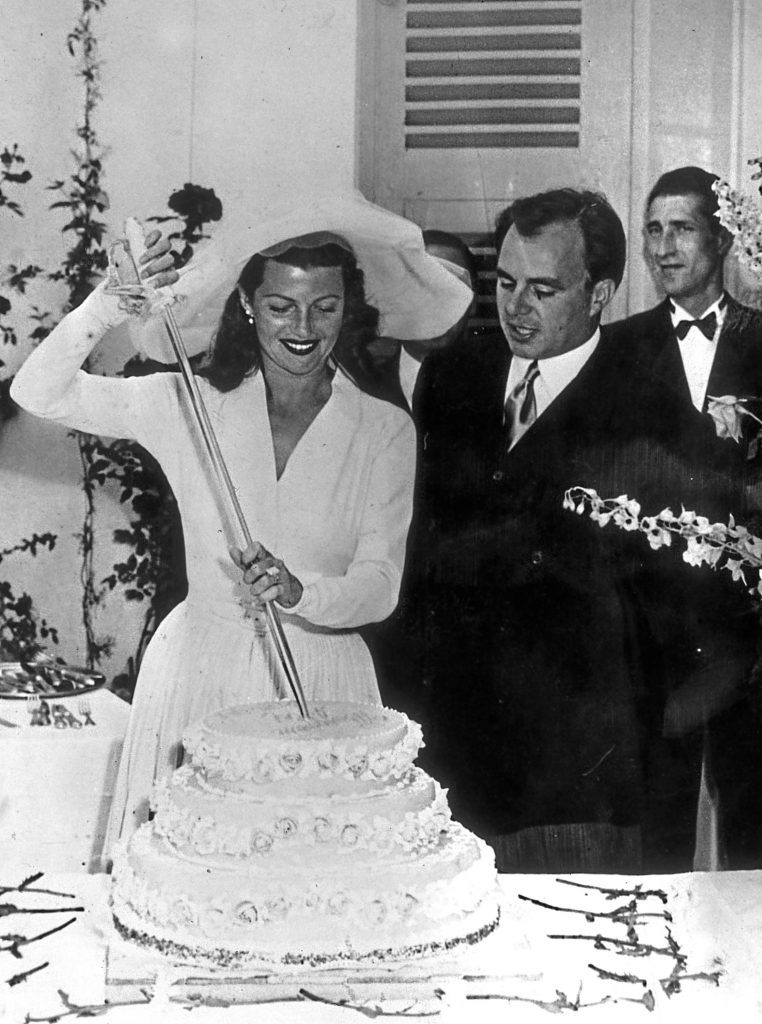 Rita Hayworth with her husband, the Prince Aly Khan, cutting the cake on their wedding day. (Keystone/Getty Images)