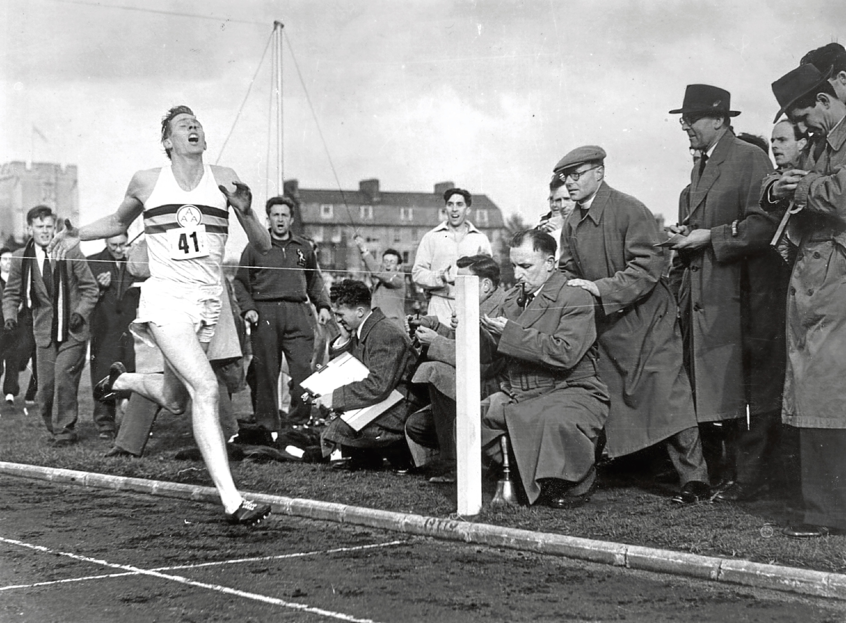 Roger Bannister about to cross the tape at the end of his record breaking mile run (Norman Potter/Central Press/Getty Images)