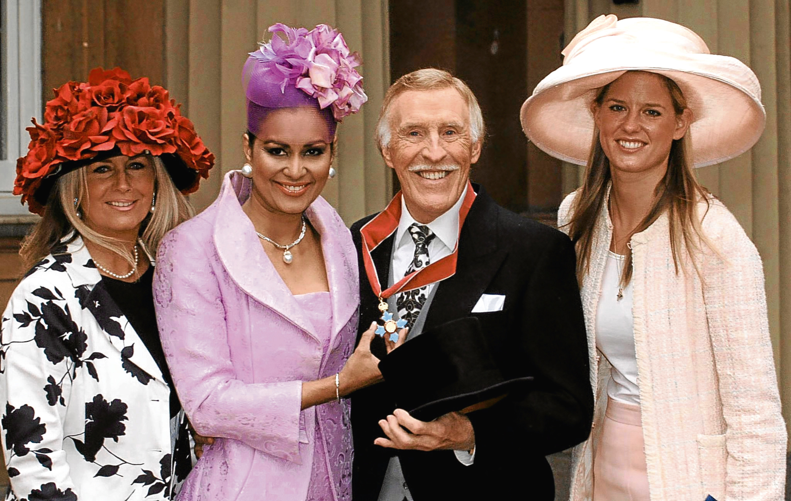 Bruce Forsyth with his wife Wilnelia and daughters Julie Purdie (left) and Louisa Monro (right) at Buckingham Palace