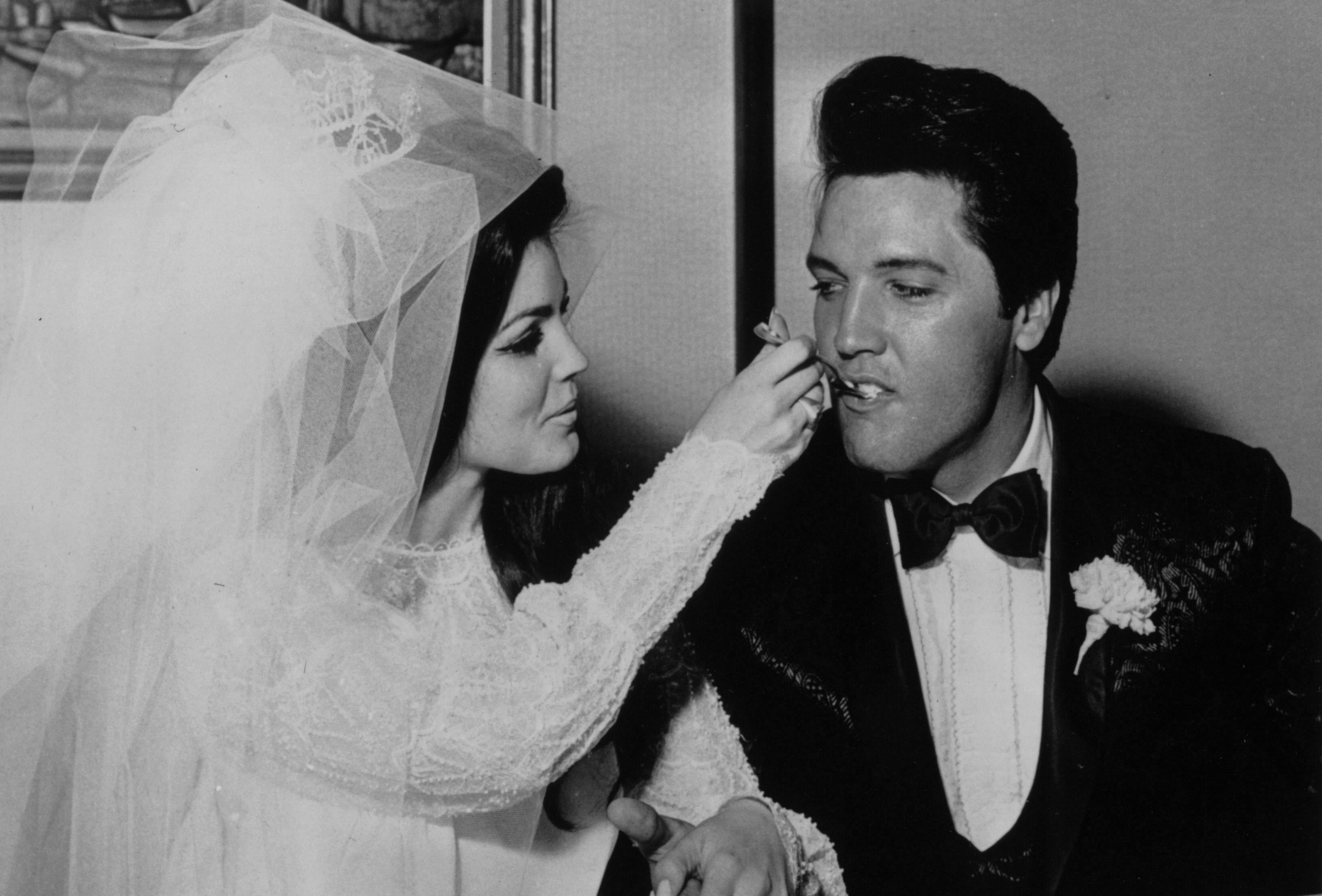 Elvis being fed a mouthful of wedding cake by his bride Priscilla at the Aladdin Hotel, Las Vegas. (Keystone/Getty Images)