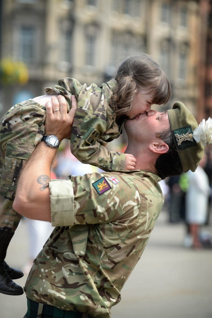 Corporal Sean Neill, from Kilmarnock, kissing his daughter Madison in the streets of Glasgow after the 400 strong Homecoming Parade. (Mark Owens/Army HQ Scotland/PA Wire)