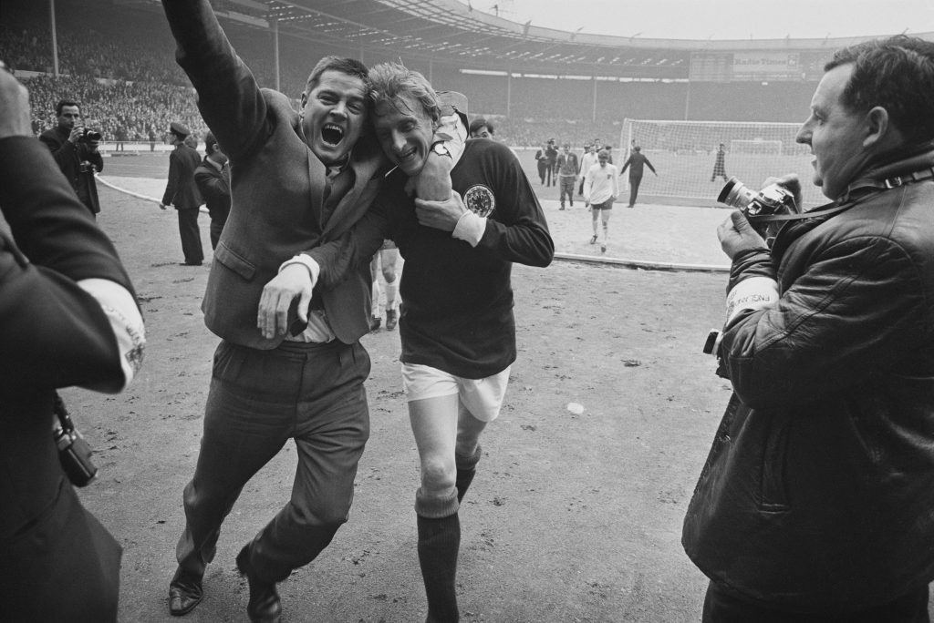 Denis Law is hugged by a fan (Larry Ellis/Express/Hulton Archive/Getty Images)