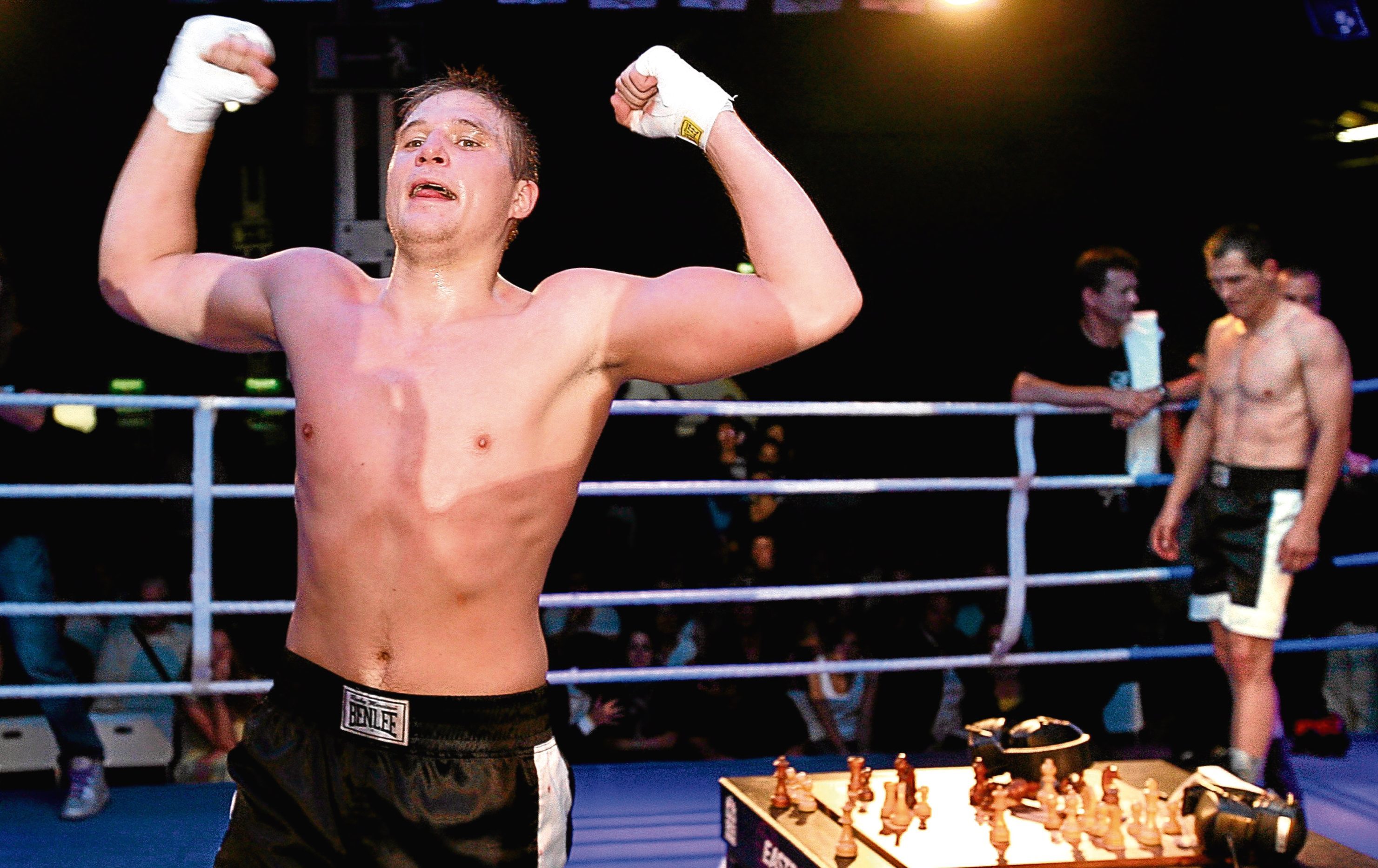 Russian Nikolay Sazhin (L) celebrates his win over German Frank Stoldt (R) after claiming the light heavyweight world championship title in chess boxing (EPA/WOLFGANG KUMM)