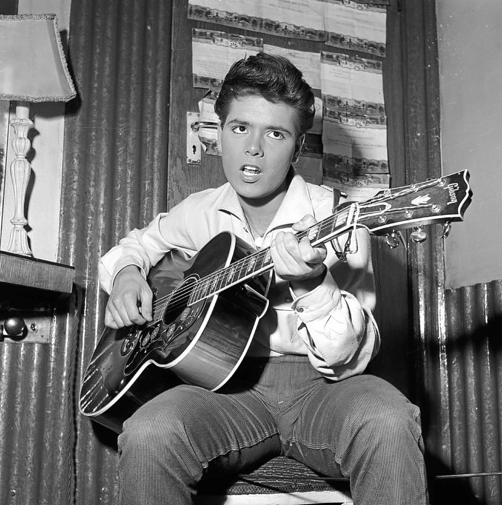 Cliff Richard strums a tune on his trusty guitar before a concert. (John Pratt/Keystone Features/Getty Images)