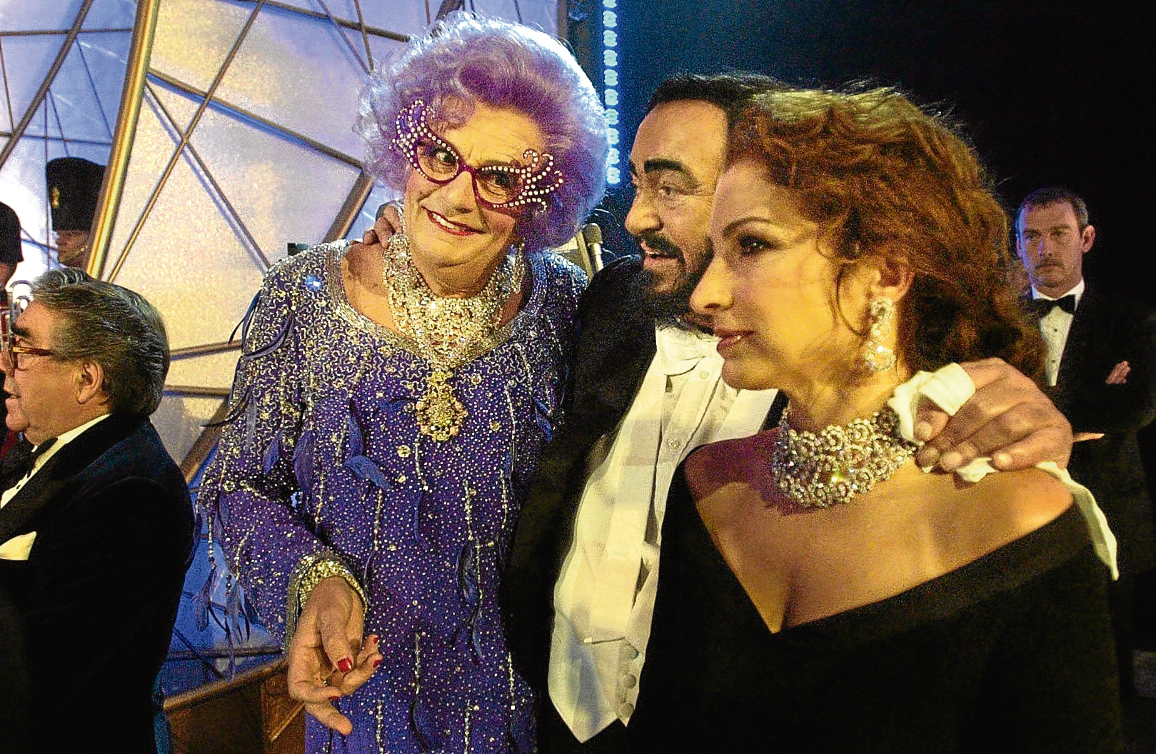 Barry Humphries, aka Dame Edna Everage, with singers Luciano Pavarotti and Gloria Estefan at the Festival Theatre, in Edinburgh, for the start of the 75th Royal Variety performance (David Cheskin / PA)