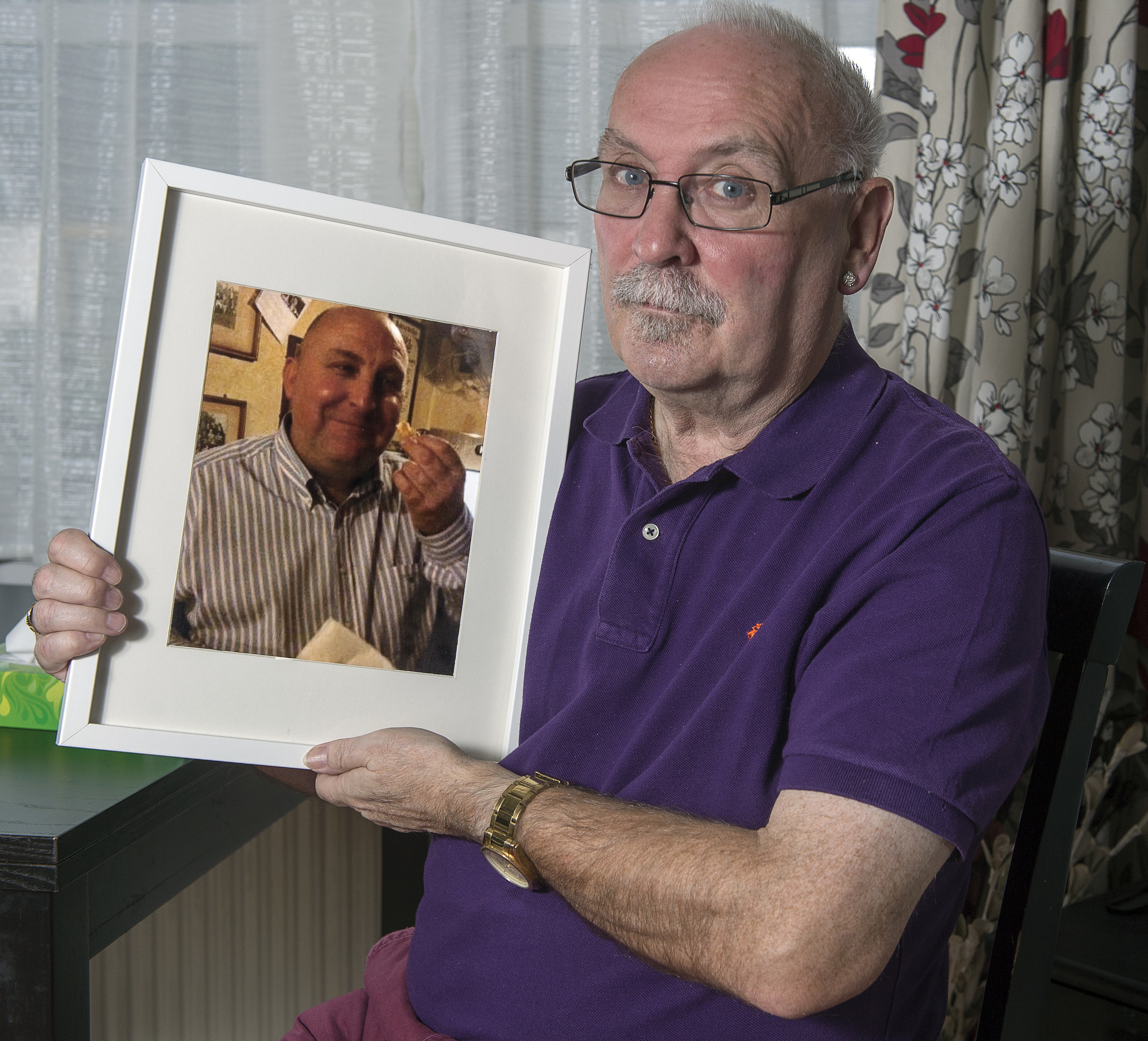 Ronnie Semple from Inverness holds a photograph of his murdered brother PC Gordon Semple - Photo - TREVOR MARTIN