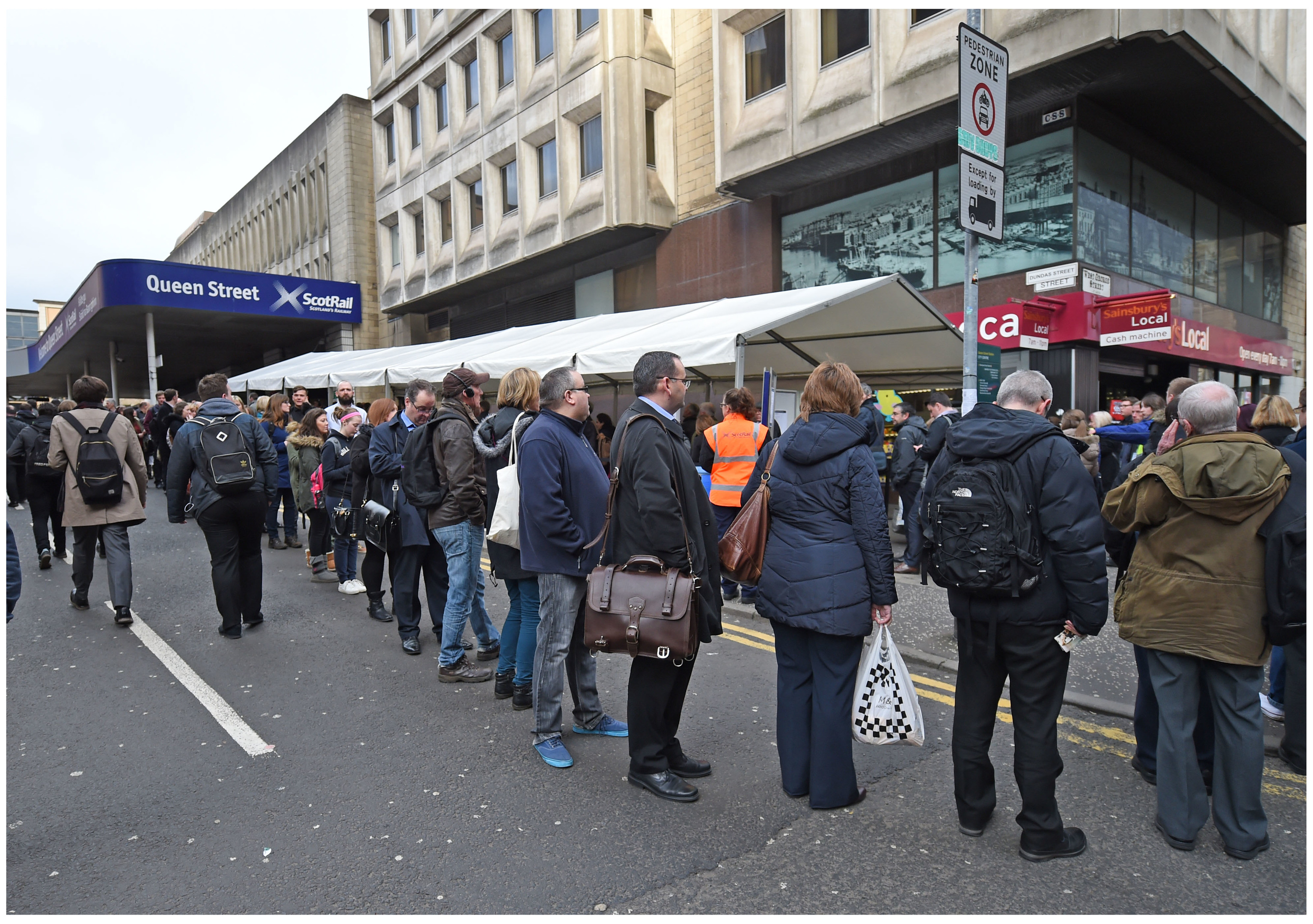 Commuters queue outside Glasgow's Queen Street railway station during electrification work which has closed the upper concourse and platforms (Daily Record)