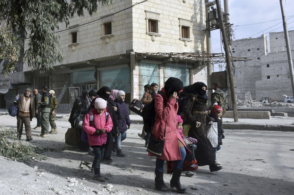 Residents flee east Aleppo as government forces push into rebel-held areas (SANA via AP)