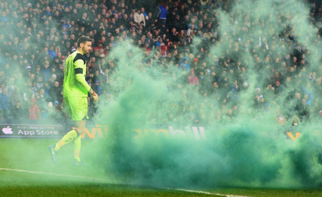 Craig Gordon of Celtic walks among smoke as a flare is thrown (Mark Runnacles/Getty Images)