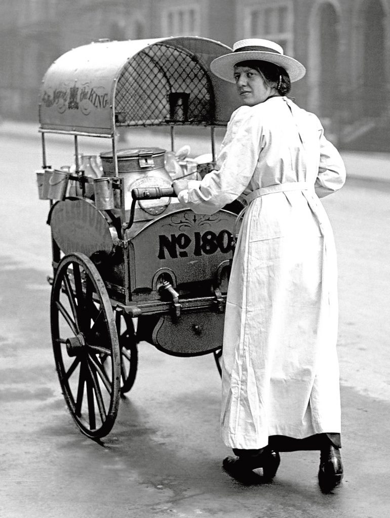 A woman delivering milk supplies in the west end of London