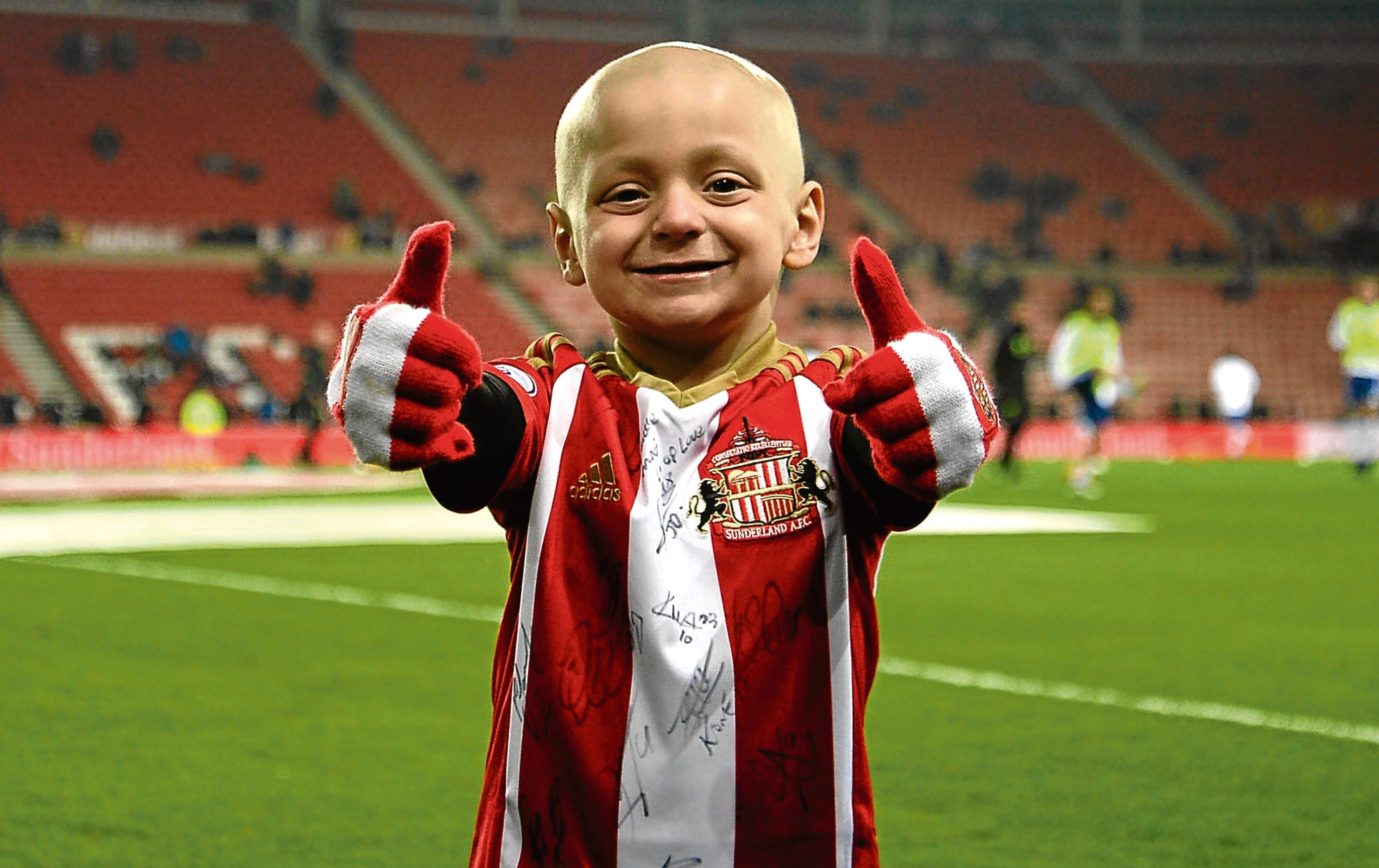 Wee Bradley’s thumbs-up for the thousands who sent him cards (PA)