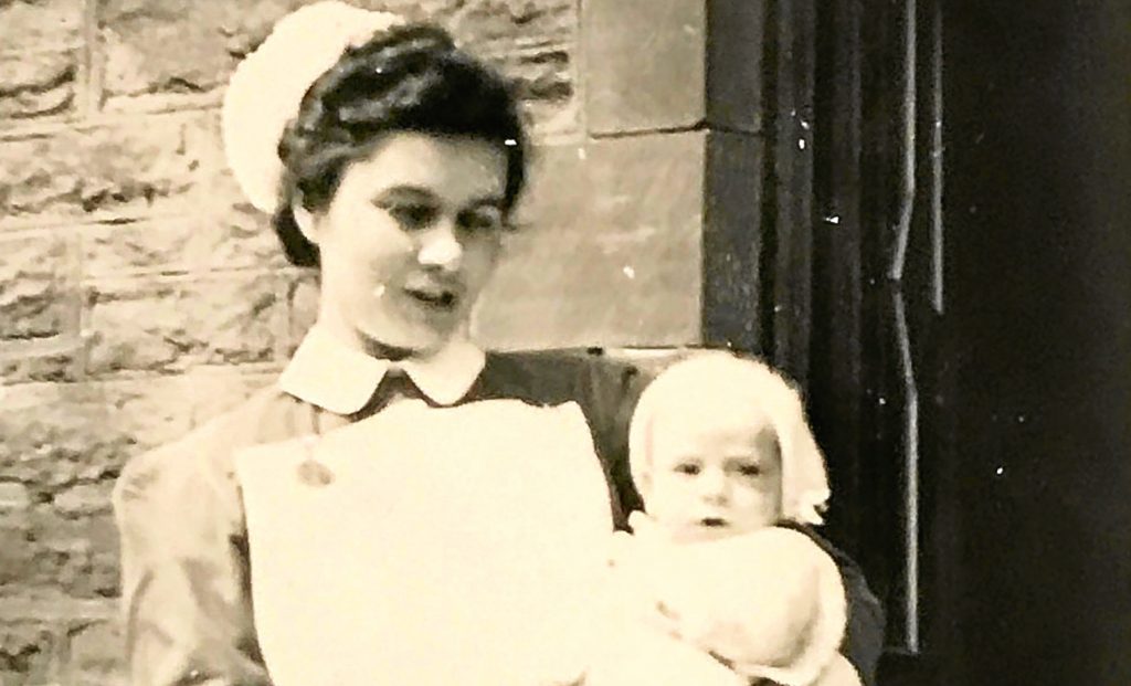 Margaret McInroy, nee Ansell, when she was a nurse with baby Bill Douglas