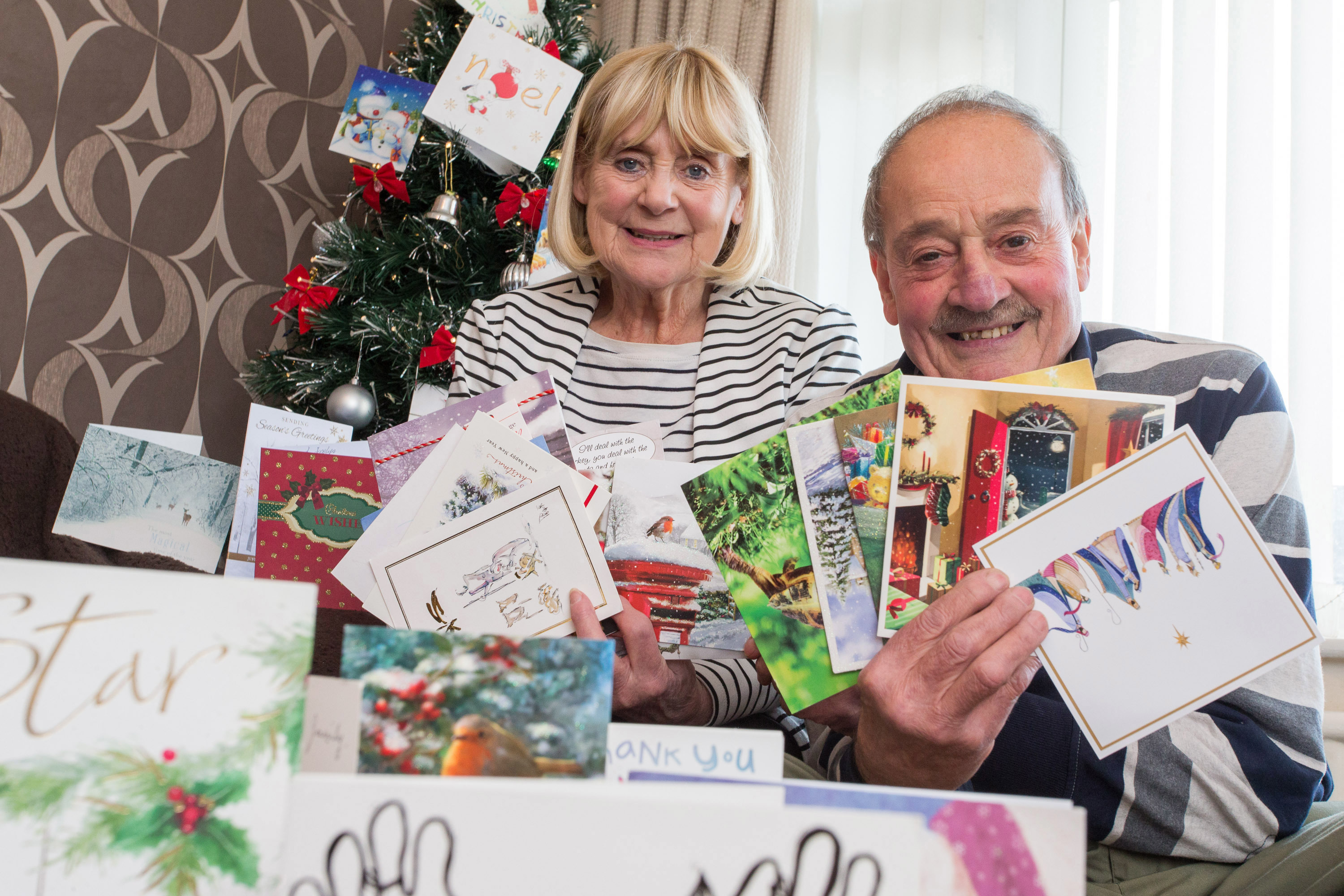 Jos and George Hindle with some of the Christmas cards they receive from the children they have fostered over the years (Bob Collier Photos)