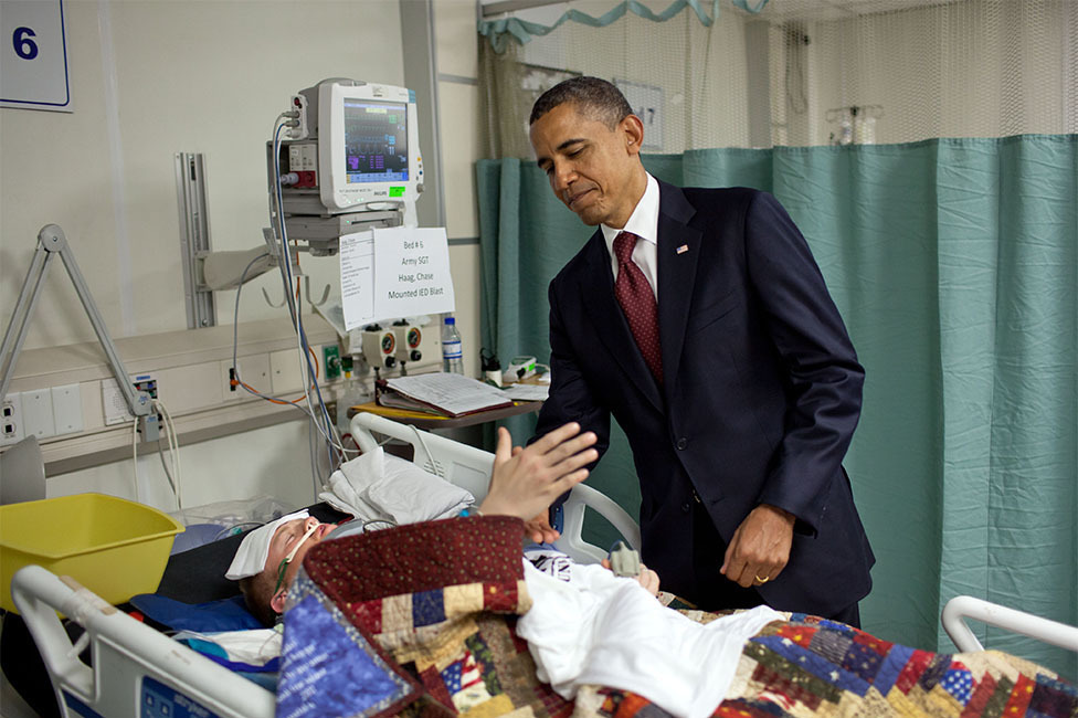 May 1, 2012 "For the President, this was one of the most poignant moments of his first term. He was visiting wounded warriors in the intensive care unit at Bagram Air Field in Afghanistan. He had just presented a Purple Heart to Sgt. Chase Haag, who had been injured by an IED just hours before. Sgt. Haag was covered with a blanket and it was difficult to see how badly he was injured. He was also seemingly unconscious, or perhaps just asleep. The President whispered in his ear so not to wake him. Just then, there was a rustling under the blanket and Sgt. Haag, eyes still closed, reached his hand out to shake hands with the President. 'I'll never forget that moment,' someone else in the room later told me." (Official White House Photo by Pete Souza)