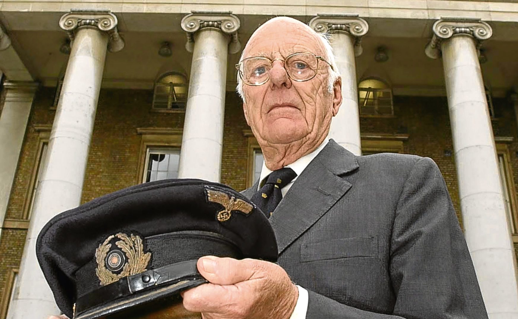 Lieutenant Commander David Balme holds the cap belonging to the submarine's commander